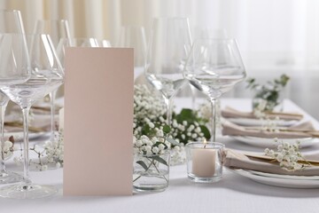 Beautiful table setting with blank card and floral decor