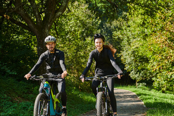 Fototapeta premium A blissful couple, adorned in professional cycling gear, enjoys a romantic bicycle ride through a park, surrounded by modern natural attractions, radiating love and happiness