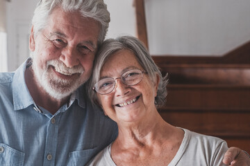 Portrait of couple of two happy and healthy seniors old people smiling and looking at the camera....