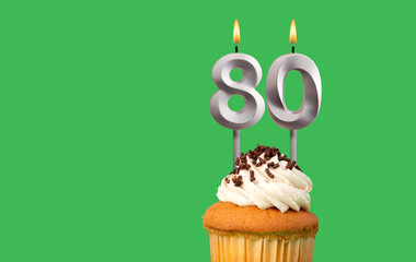 Birthday card with candle number 80 - Cupcake on green background