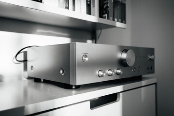 Frankfurt, Germany - Dec 12, 2022: Black and white image of an Onkyo 9150 hi-fi amplifier on Vitsoe 606 shelves, highlighting the minimalist and functional design in a living room