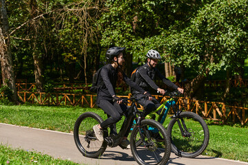 Fototapeta premium A blissful couple, adorned in professional cycling gear, enjoys a romantic bicycle ride through a park, surrounded by modern natural attractions, radiating love and happiness