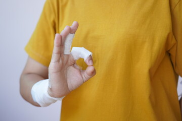 Asian and African male hands with elastic bandages on white background. Wrist wound, bandage, hand wound, painkiller