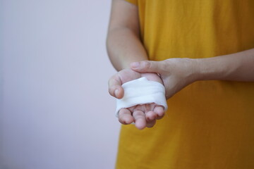 Asian and African male hands with elastic bandages on white background. Wrist wound, bandage, hand wound, painkiller