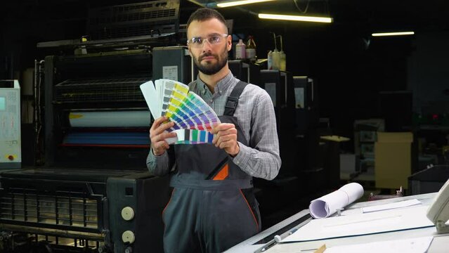 Designer holding swatch palette in hand at print factory