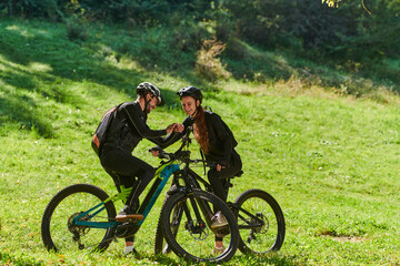 Fototapeta premium A sweet couple, equipped with bicycles and engrossed in coordinating their journey, checks their GPS mobile and watches while planning scenic routes in the park, seamlessly blending technology and
