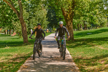 A blissful couple, adorned in professional cycling gear, enjoys a romantic bicycle ride through a park, surrounded by modern natural attractions, radiating love and happiness