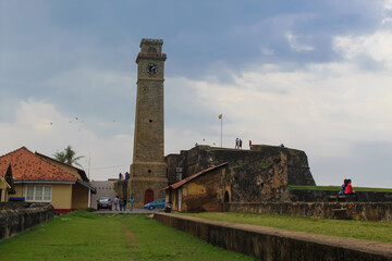 Birds flying over the old clock tower at Galle Dutch Fort 17th Century.
