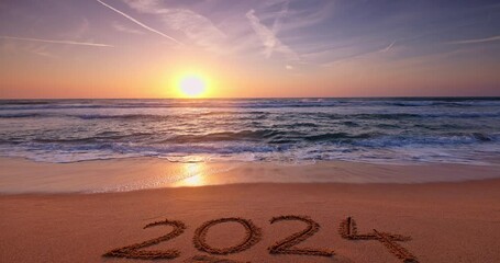 Tropical beach sunrise and text on sea sand happy new year 2024 inspirational nature background