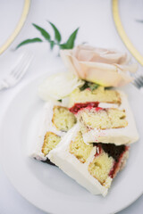 Wedding cake slices on elegant tablescape with rose