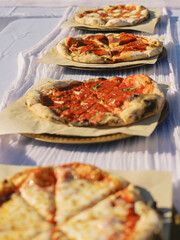 Assorted wood-fired pizzas on a table