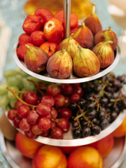 Vibrant fruit display on a three-tiered dessert stand