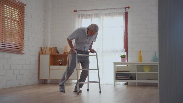 Asian senior elderly male fall on the ground while walk alone in house.