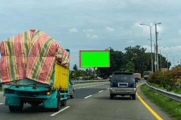 Blank green screen billboard at the highway. Copy space signboard or outdoor billboards on freeway, Concept of announcements and advertisements
