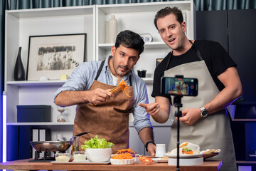Healthy food in kitchen with chef influencers presenting fresh salad roll on cooking show streaming...