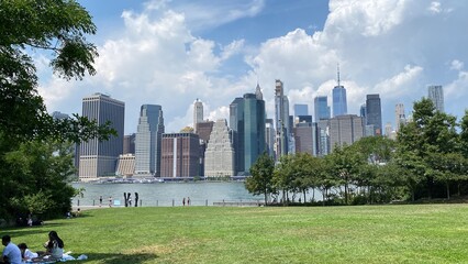 A crowd on a sweltering hot summer day in BROOKLYN BRIDGE PARK in DUMBO, New York in 2022. It is an 85-acre park on the Brooklyn side of the East River in New York City