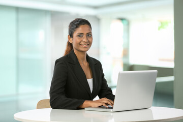 Indian business woman working on a laptop.