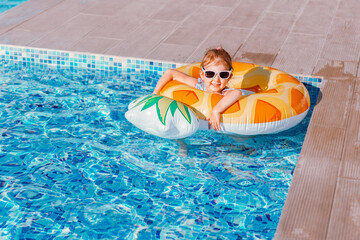 Little girl having fun in swimming pool.