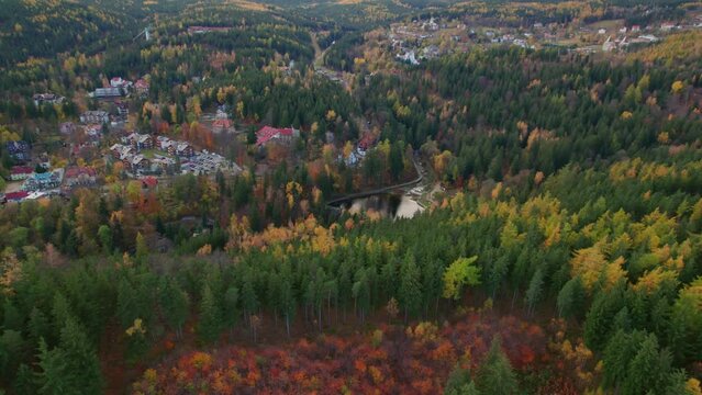 Karpacz, Poland, autumn drone tilt-down view of a mountain city, zapora na łomnicy