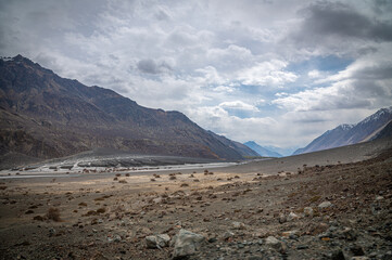 Scenic view of Himalayas and Ladakh ranges. Beautiful barren hills in Ladakh with dramatic clouds in the background.  View from the road from Nubra Valley to Turuk. Siachen area in Leh Ladakh.