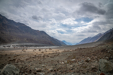 Scenic view of Himalayas and Ladakh ranges. Beautiful barren hills in Ladakh with dramatic clouds in the background.  View from the road from Nubra Valley to Turuk. Siachen area in Leh Ladakh.