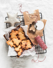 Christmas homemade edible gift - butter cookies and Christmas decor on a light background, top view