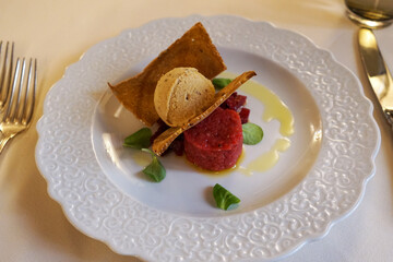 Close up dish of traditional beef Tartare, raw ground beef or horsemeat served with onions, capers, pepper, Worcestershire sauce, and other seasonings