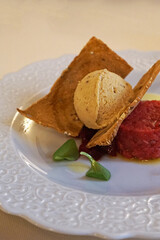 Close up dish of traditional beef Tartare, raw ground beef or horsemeat served with onions, capers, pepper, Worcestershire sauce, and other seasonings