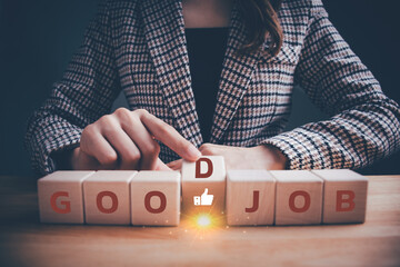Businesswoman in checkered suit hand flipping wooden blocks GOOD JOB text to thumbs up symbol....