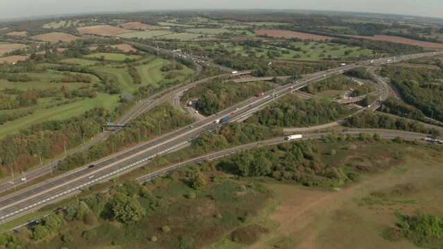 Rising aerial slider shot over M25 M11 motorway road interchange Essex