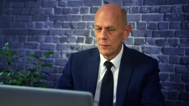 A negative business man talking on a video conference call unhappy and disapproving