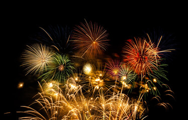 Fireworks show under defocus or blur concepts with isolated black background at night, this...
