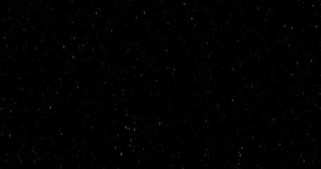 Cinematic snowfall loop animation of a surreal realistic snowflake falling bg. Snowfall winter overlay slowly falls on a black backdrop. Snowflake for Christmas new year 2024,2025.