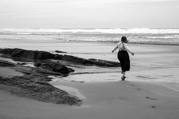 Woman on remote coastline in central Oregon