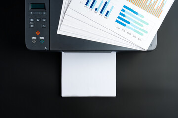 Modern laser printer on black background close up