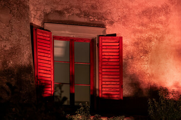 Red shutters at night on Tuscan farmhouse