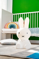 Toy rabbit lamp in nursery room close up.