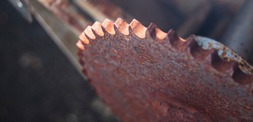 Close up of an old rusty circular saw blade. Shallow depth of field.
