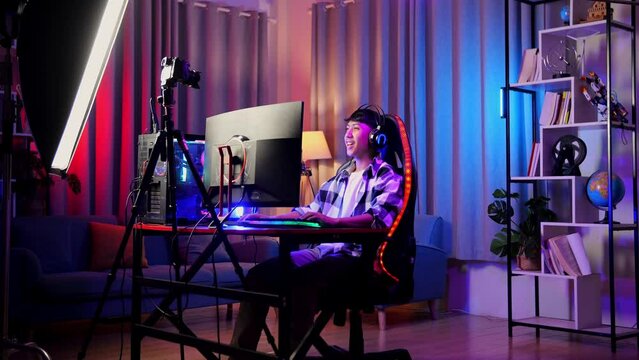 Asian Boy Streamer Celebrating Winning Game On Personal Computer

