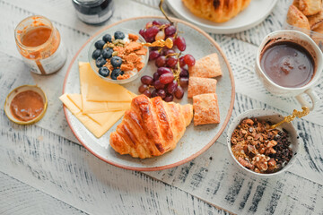 Breakfast: croissants, yogurt, fruit and coffee.