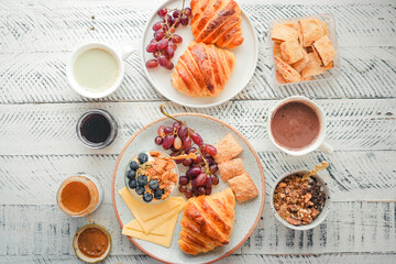 Breakfast: croissants, yogurt, fruit and coffee.