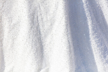 White wedding dress as an abstract background. Texture