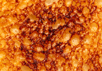 Bread fried in a toaster as an abstract background. Macro