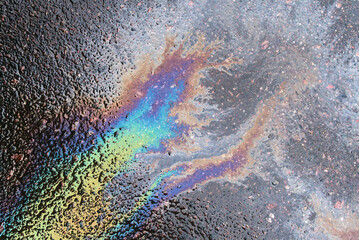 Beautiful colorful patterns with the transfer of texture after spilling oil or gasoline on wet asphalt.