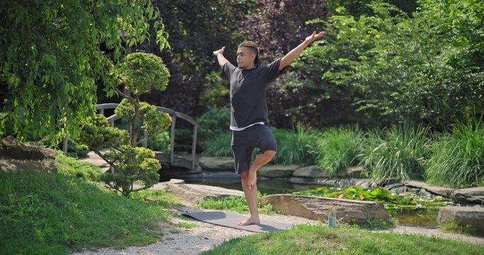 Healthy african american man exercising ar park outdoor practicing yoga