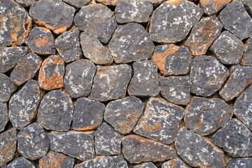 Flat lay photograph of a colorful stone wall. Stone background texture