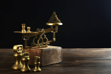 Black caviar on scales. Vintage brass scales are out of focus. An exquisite and expensive snack....