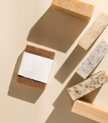 Beige and brown soap bars on light beige top view, hard shadows, packaging mockup