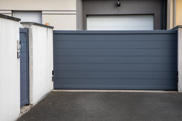 Aluminum door steel dark gray metal house gate street portal of suburb access home - obrazy, fototapety, plakaty