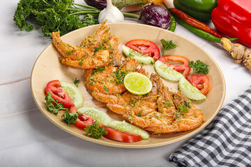 Grilled prawn served lime and vegetables